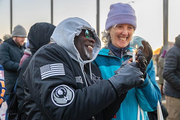 Voices raised for peace and change on MLK Day-Richmonders marked Martin Luther King Jr. Day with a series of events, including Virginia Union University’s 47th annual community leaders breakfast, a candlelight vigil for peace outside the Virginia War Memorial, and Lobby Day rallies for gun violence prevention and gun rights at Capitol Square. MLK Vigil and protest at War Memorial-James Saxsmo Gates, with the Southern Christian
Leadership Conference, and Debby Fagan work together to light candles during the vigil on Jan. 19. The event was also a protest of Trump administration policies and deaths linked to ICE activity.(photo by Julianne Tripp Hillian/Richmond Free Press)