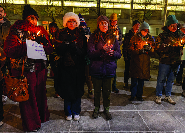 Cityscape Slices of life and scenes in Richmond-On a cold Thursday evening in Richmond, a small group of residents and city leaders gathered to honor victims of traffic fatalities and reflect on the lives left behind. Bike Walk RVA’s vigil at 6 p.m. Jan. 29 drew a few dozen community members, some holding candles and signs in remembrance of loved ones lost. The vigil concluded with remarks from Cathy Fleming, who shared the story of her daughter, Lauren Mychelle Jones, who was killed Nov. 29 after being
struck by a vehicle on West Carnation Street. Fleming is pictured at far left alongside her niece Chloe Jackson. At right is Natalie Rainer, engagement manager for Bike Walk RVA. (photo by Julianne Tripp Hillian/Richmond Free Press)