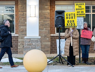 Superintendent Jason Kamras watched as members of the Richmond Education Association rallied outside River City Middle School on Monday to protest proposed cuts in the school division’s fiscal year 2027 budget ahead of a Richmond School Board town hall meeting. Julianne Tripp Hillian/Richmond Free Press