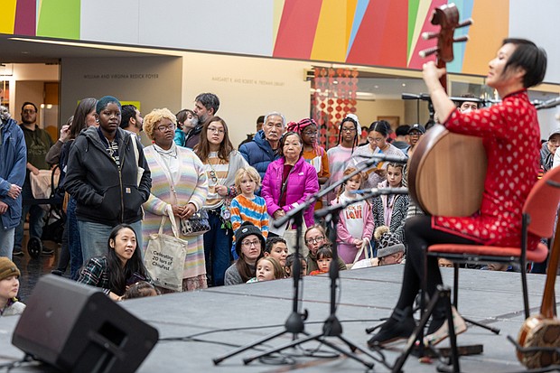 Lunar New Year celebrated at VMFA-The Virginia Museum of Fine Arts celebrated the Lunar New Year on Saturday, Feb. 7 with the museum’s annual ChinaFest celebration. The “Year of the Fire Horse” event featured art activities, dance and music performances, kung fu and calligraphy demonstrations.Min Xiao-Fen plays the pipa, a traditional Chinese
instrument, for a crowd gathered in the Cochrane Atrium. (photo by Julianne Tripp Hillian/Richmond Free Press)