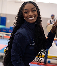 Simone Biles poses for a photo while visiting young gymnasts in Milan, Italy, in February.