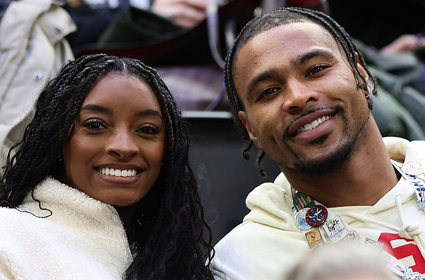 Simone Biles and her husband, NFL player Jonathan Owens, attend a hockey match at the Olympics in Milan, Italy.