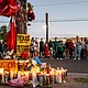 People pay their respects during a candlelight vigil in Houston Wednesday at the site where Lorenzo Salgado Araujo was killed.