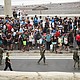 Police officers and Spanish soldiers escort a big group of migrants to the border to take them out of Spain, after mass crossings of migrants on foot and by sea from Morocco into Spanish territory, in Ceuta, Spain, on August 1.