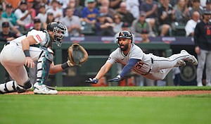 Detroit Tigers Riley Greene dives to home and scores off a two-run single from Colt Keith against the Seattle Mariners on Tuesday.