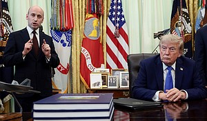 White House deputy chief of staff Stephen Miller speaks while President Donald Trump listens during an event to sign executive orders in the Oval Office of the White House, on August 6, 2026.