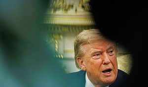 Trump answers questions from reporters in the Oval Office of the White House in Washington, DC on August 17.
