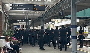 Far-right protesters stand at the Dover Priory train station in southern England after their demonstration blocked roads at the port during an anti-migration protest.
