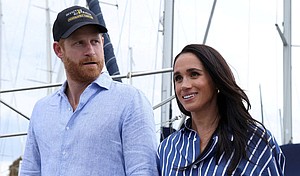 Prince Harry and Meghan, the Duke and Duchess of Sussex, disembark after sailing on Sydney Harbour, Australia, in April.