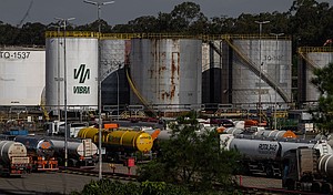 Trucks near oil storage tanks at a Petrobras refinery in Paulinia, Brazil. Oil exports have risen in the wake of the US-Iran war.