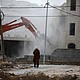 Israeli excavator demolishing a Palestinian-owned building