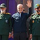 Iranian President Masoud Pezeshkian waves as demonstrators in Tehran chant slogans against the US and Israel on September 18.
