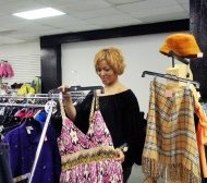Kamla Hodges-Ronan arranges clothing at the 79th Street Indoor Mall. Photo/Deborah Bayliss