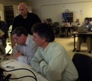 (L to R) Dr. Mikhail Korenman, head of the Cook County Jail chess program and Cook County Sheriff Tom Dart, address local media who were at the jail and Anatoly Karpov, a legendary Russian chess grandmaster and former world champion via Skype, during a press conference that preceded a first-ever, international chess game between Russian jail inmates and Cook County Jail inmates. Photo/Deborah. Bayliss