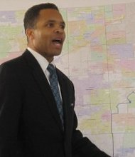 Congressman Jesse Jackson, Jr. shows members of the Healthcare Consortium of Illinois a map of his district at the group's general assembly meeting Jan 30. (Photo by Thelma Sardin)