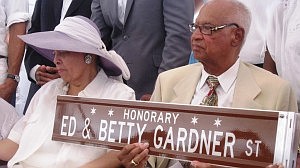 Ed Gardner (left)  holds a new street sign that bears he and his wife's name.  The Gardners' are the founders of Soft Sheen Products. (Photo by Thelma Sardin)