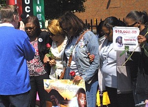 Mothers of slain Chicago area youth and young adults were led in prayer Sunday by Rev. Michael Pfleger of St. Sabina.  The mothers gathered outside the Catholic church in the Auburn-Gresham community on Mother's Day morning to remember their children and called for an end to gun violence. Photo by Rhonda Gillespie