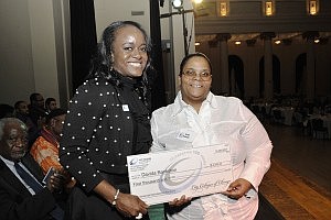 Caption: Davida Bankston, right, receives a $2,500 scholarship Friday from City Colleges of Chicago Chancellor Cheryl Hyman during CCC's Centennial celebration. City Colleges was founded in 1911 with one school and 30 students in the first class. Now there are over 120,000 students and seven schools in the CCC system. (Photo: City Colleges of Chicago)