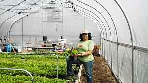 Renelda Gardner of the Chicago Botanic Garden holds a head of lettuce grown in a clay pot container. Gardner is an instructor/grower with the Botanic Garden's, Green Youth Farm program situated at Dyett High School in Hyde Park. Students from high schools throughout the city will take part in the program this spring and a Farmer's Market that will run from June to Oct.  Photo by Deborah Bayliss