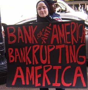 Protestor Alaa Mukahhal, member of the Arise Chicago organization, holds an anti-Bank of America sign outside of its 135 S. Lasalle location.     Photo by Abbrea Stiffend