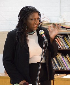 Tara Stamps, a middle school teacher at Jenner Academy of the Arts speaks during the Austin town hall meeting regarding longer Chicago Public Schools school days. Photo Truss Digital Photograph