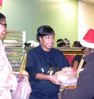 Johnson Publishing Company signed on again this year to help sponsor Operation Hope, a community outreach feeding event by St. Sabina church. Representatives from JPC helped pass out the 2,000 pre-packaged BJ's Market and Bakery restaurant meals of chicken or ham, macaroni and cheese, greens and a corn muffin. (Photo Credit: Rhonda Gillespie)