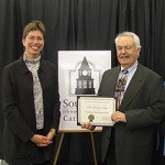 Lieutenant Governor Sheila Simon presents SSC Historian Dave Bartlett with an Illinois State Historical Society Award for the colleges Dixmoor Historical Wall.