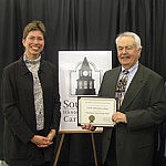 Lieutenant Governor Sheila Simon presents SSC Historian Dave Bartlett with an Illinois State Historical Society Award for the colleges Dixmoor Historical Wall.