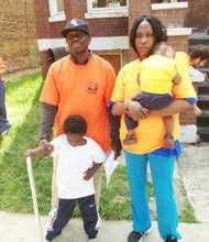 Ezekiel and Shantisha Shaw with two of their five children outside of their home where their lights and cooking gas have been turned off due to an unlawful eviction case. Photo: Lee Edwards